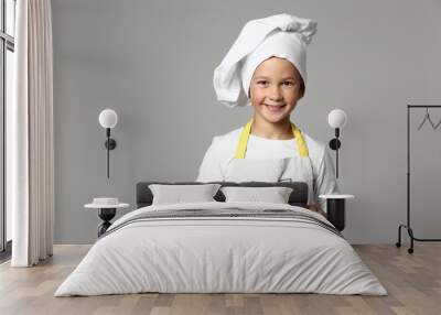 cute little chef with tasty dessert on grey background Wall mural