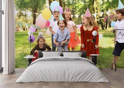 Cute little children at birthday party outdoors Wall mural