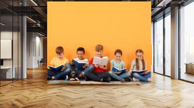 Cute little children reading books on color background Wall mural