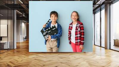 Cute little children with movie clapper on color background Wall mural