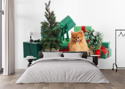 Cute Pomeranian dog with Christmas tree, wreath and gifts on white background Wall mural