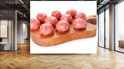 Cutting board with raw meat balls on white background Wall mural