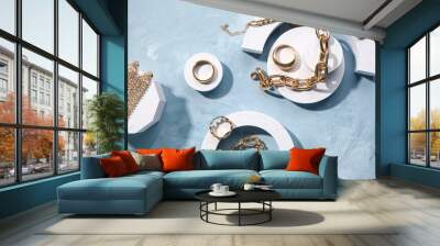 Decorative podiums with beautiful golden jewellery on grunge blue background Wall mural