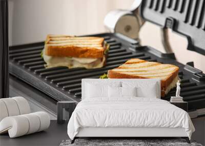 Delicious sandwiches in modern electric grill, closeup Wall mural