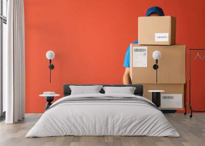 Delivery man with boxes on color background Wall mural