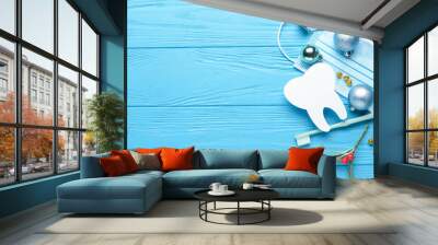 Dentist's supplies and Christmas decor on color wooden background Wall mural