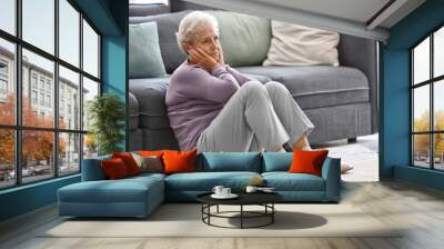 Depressed elderly woman at home Wall mural