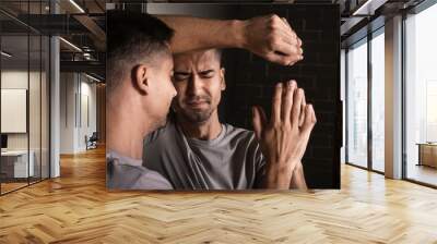 Depressed young man near mirror Wall mural