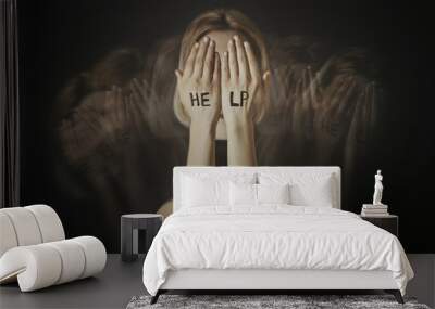 Depressed young woman on dark background Wall mural