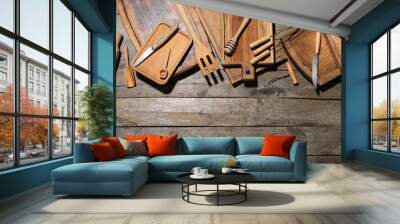 Different cutting boards, knives, skewers and corkscrew on wooden background Wall mural