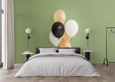 Different Halloween balloons on green background Wall mural