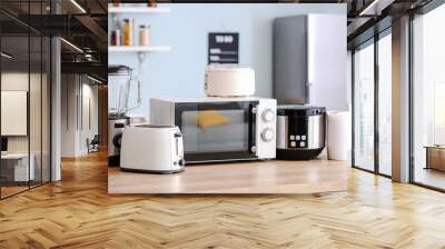 Different household appliances on table in kitchen Wall mural