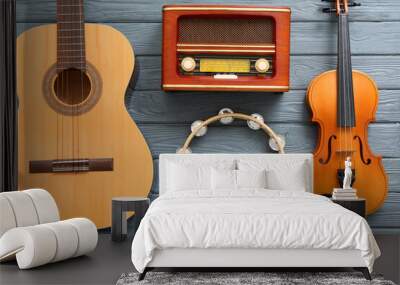 Different musical instruments and retro radio receiver on wooden background Wall mural