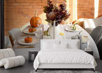 Dining table with pumpkins and flowers near brick wall Wall mural