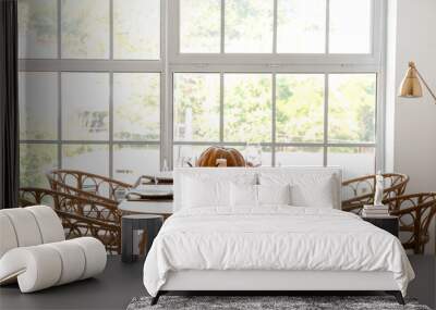 Dining table with pumpkins near window in room Wall mural