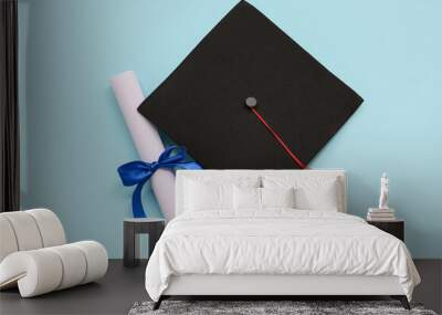 Diploma with blue ribbon and graduation hat on light blue background Wall mural