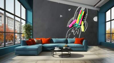 Drawn rocket with stationery on black background Wall mural