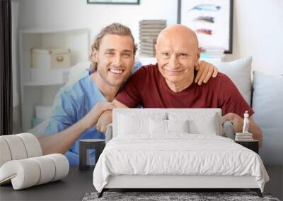 Elderly man with caregiver in nursing home Wall mural