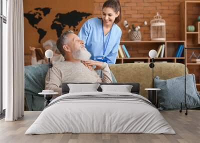 Elderly man with caregiver in nursing home Wall mural