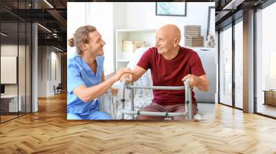 Elderly man with caregiver in nursing home Wall mural