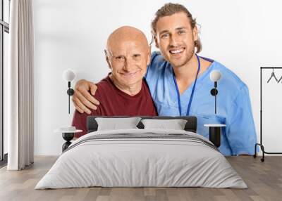 Elderly man with caregiver on white background Wall mural