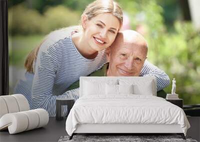 Elderly man with his daughter in park Wall mural