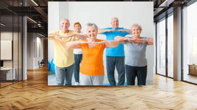 Elderly people exercising in gym Wall mural