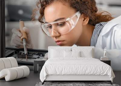 Electronic technician working in service center Wall mural