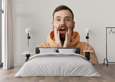 Emotional bearded man on grey background Wall mural