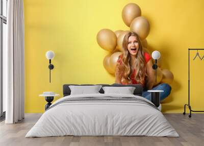 Emotional young woman with balloons on color background Wall mural