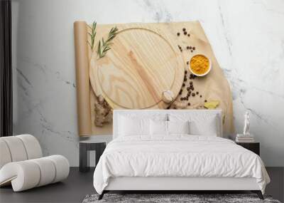 Empty cutting board with spices on light background Wall mural