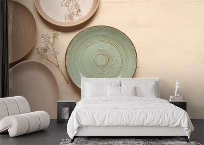 Empty plates and floral decor on beige background Wall mural