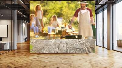 Empty wooden table at barbecue party outdoors Wall mural