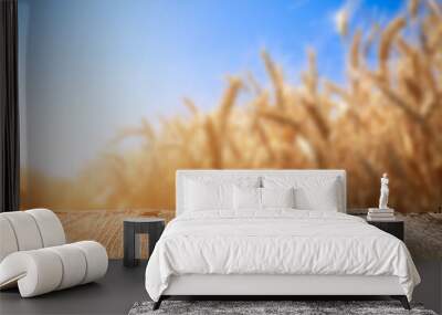 Empty wooden table in golden wheat field Wall mural