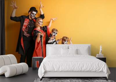 Family in Halloween costumes on color background Wall mural