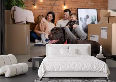 Family with cardboard boxes after moving into new house Wall mural