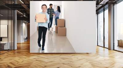 Family with cardboard boxes moving into new house Wall mural