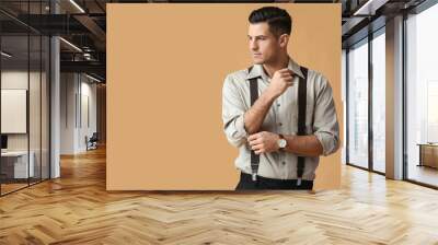 Fashionable gentleman adjusting sleeve on color background Wall mural