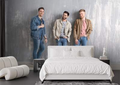 Fashionable young men near grey wall Wall mural