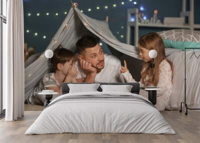 Father and his little children reading bedtime story at home Wall mural