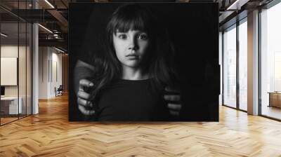 Father with his scared little daughter on dark background. Concept of domestic violence Wall mural