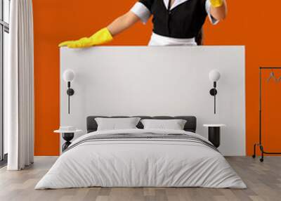 Female chambermaid with blank poster showing 