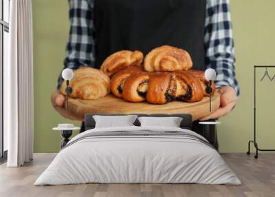 Female chef with bakery products on color background, closeup Wall mural