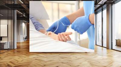 Female doctor working with patient in hospital room, closeup Wall mural