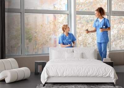 Female doctors drinking coffee in clinic Wall mural