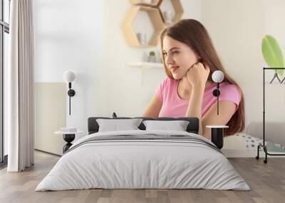 Female freelancer working on laptop in home office Wall mural