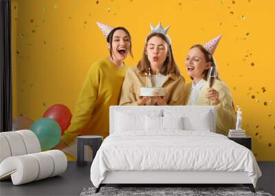 Female friends celebrating Birthday on yellow background Wall mural