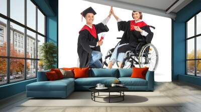 Female graduate in wheelchair and her classmate with diplomas giving each other high-five on white background Wall mural