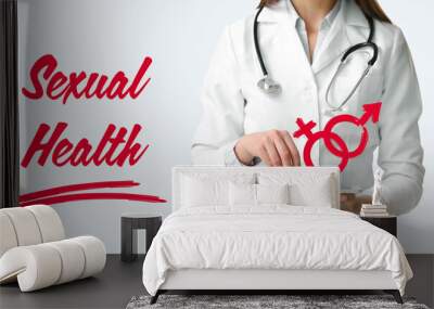 Female gynecologist with tablet computer on light background. Concept of sexual health Wall mural