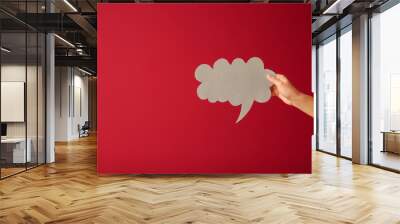 Female hand with blank speech bubble on color background Wall mural